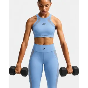 Women wearing a blue compression sports bra during gym fitness training.